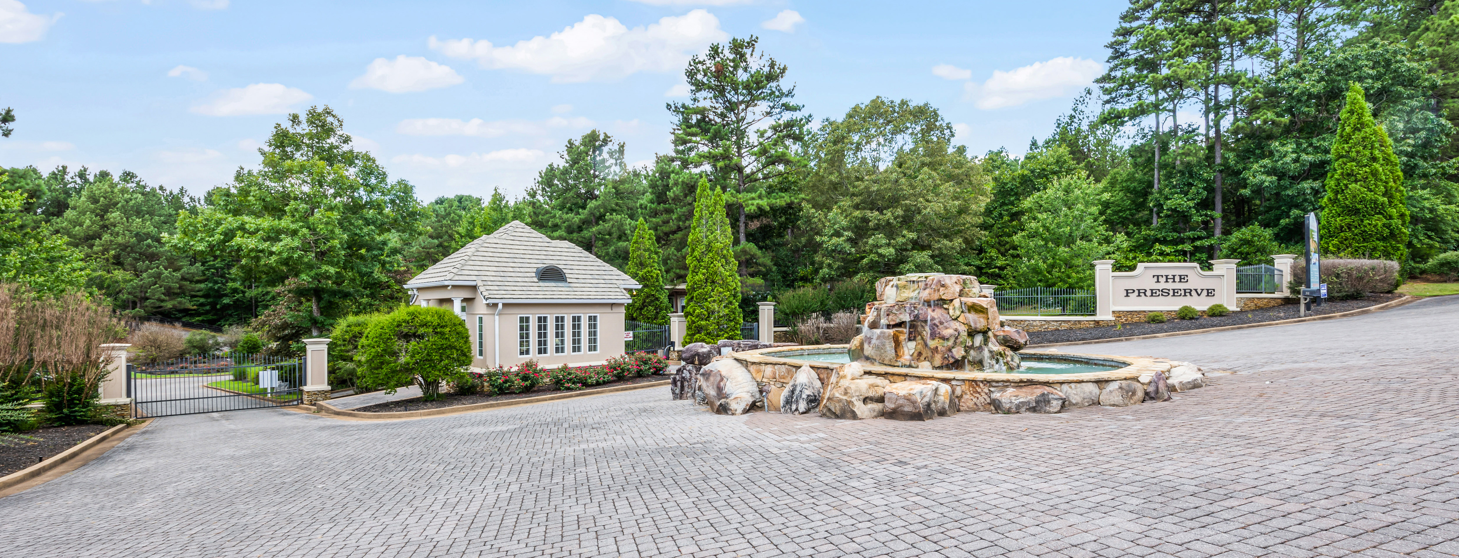 Beautifully Landscaped Secure Gated Entrance with Brick Paver Entry, a Waterfall Feature, and Guard House Awaits at The Preserve at Pickwick Lake